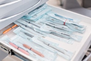 Sterilized dental instruments stored in a supply drawer — organized inventory is key to avoiding overpaying for supplies